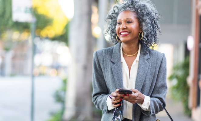 Buffini & Company Certified Real Estate Coach with Phone in Hand