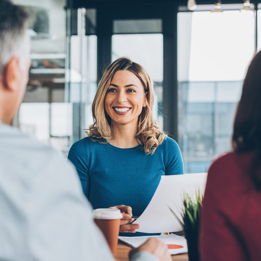 A real estate agent in Blue dress talking to client